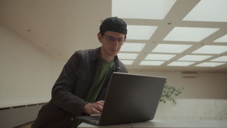 young it professional working on laptop in modern office