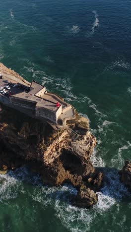 aerial view of nazare coastline in portugal with waves cliffs and atlantic ocean