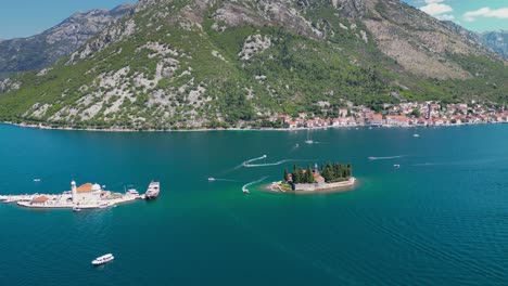 sveti dorde island, montenegro, aerial view. church of our lady of škrpjela and saint george monastery. perast city in background. drone track right. famous travel destination.