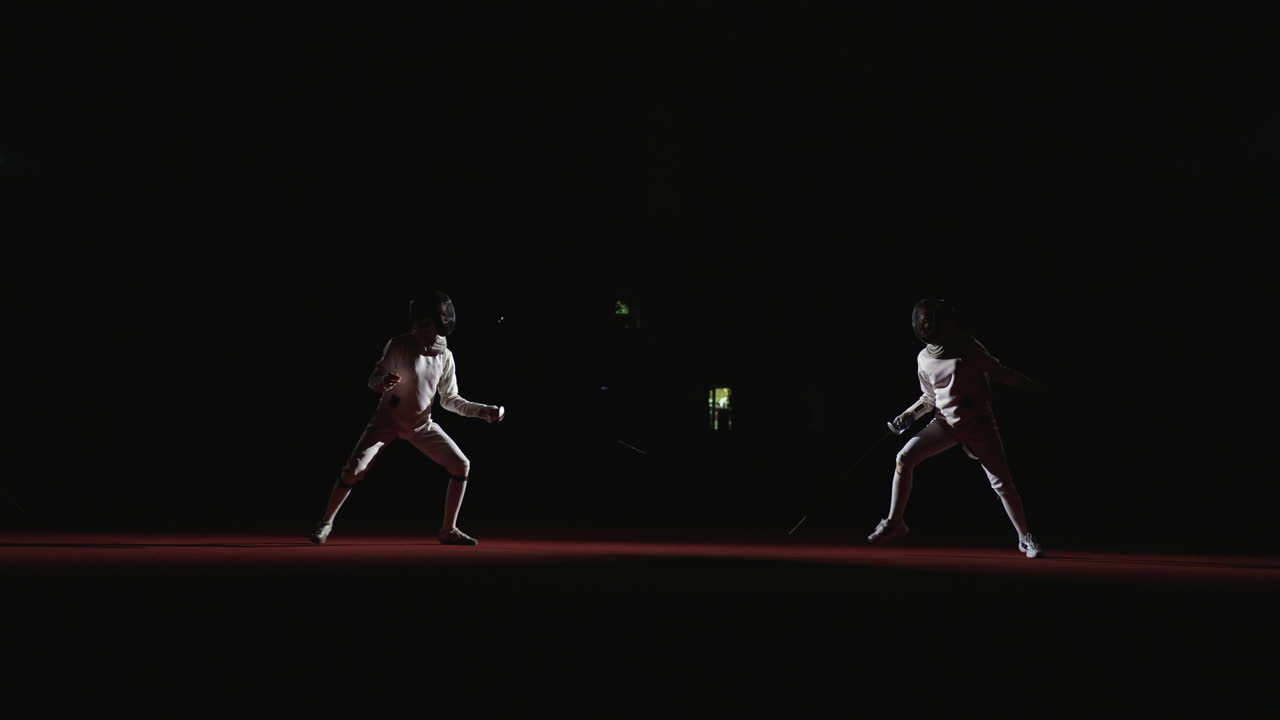 Two fencers compete in a match