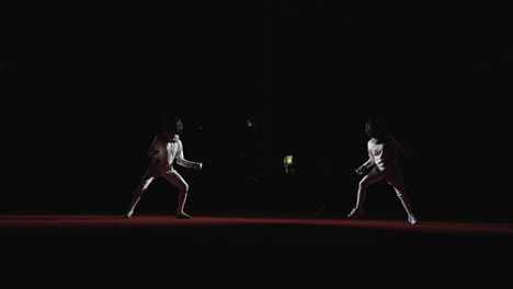 two fencers compete in a match