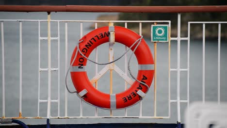 orange lifebuoy of the aratere ferry traveling from wellington to picton in new zealand