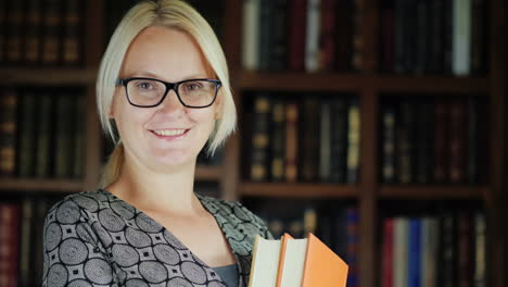 Woman-Holding-Books-in-a-Library