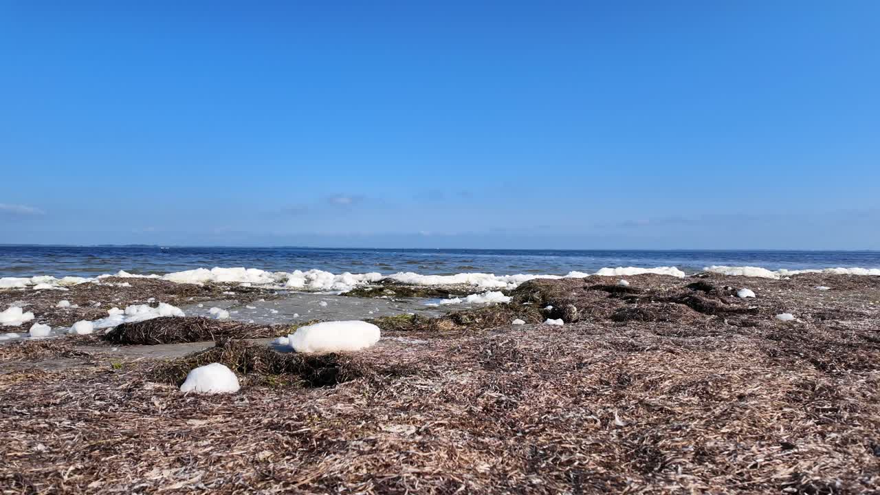 Spray and algae close-up in front of deep blue water 4k 60fps slow motion