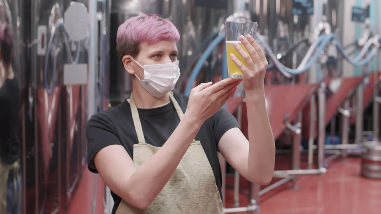 Female Brewery Worker With Freshly Made Beer