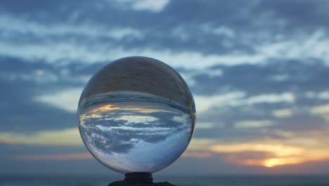 magic sunset view on the beach in a crystal ball.