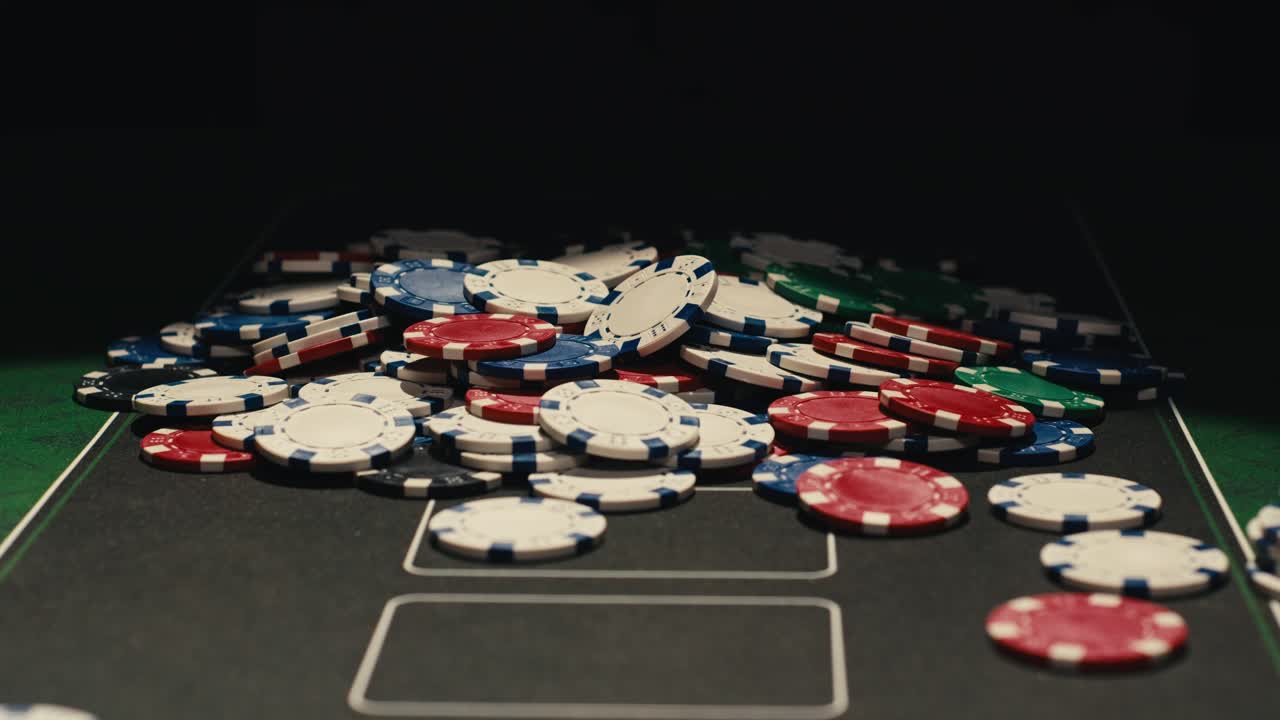 Hands managing poker chips on green table, reflecting intense poker gameplay with the element of chance and skill