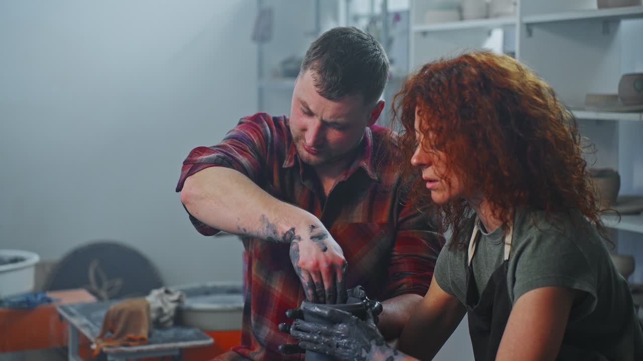 Pottery class: Two people making a pot