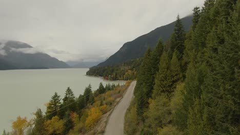 beautiful aerial landscape view of a scenic road in canadian nature during a cloudy autumn day