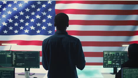 cyber defense experts in a governmental tech room with the american flag