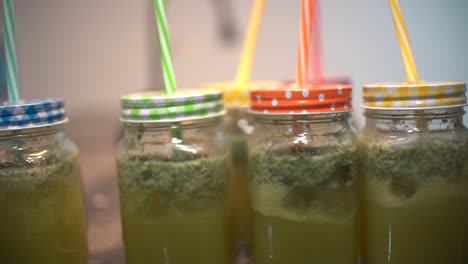 young latin girl prepare cocktail mocktail or smoothie at her kitchen