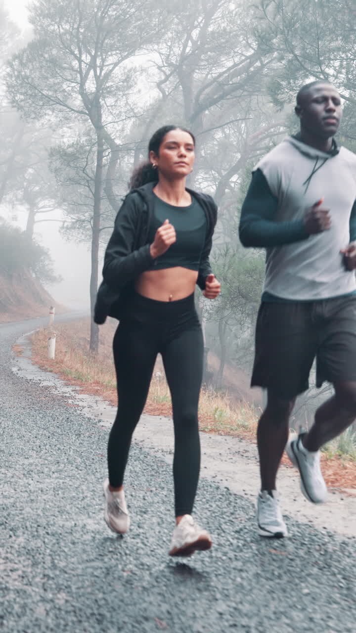 Determined Couple Running on a Misty Forest Road