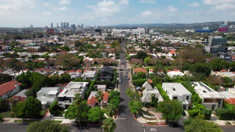 west hollywood suburb with the los angeles skyline in the distance - aerial daytime flyover