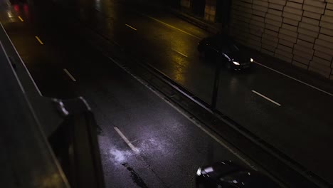 Cars-seen-from-above-at-night-driving-on-motorway-in-Shepherd's-Bush,-London,-UK