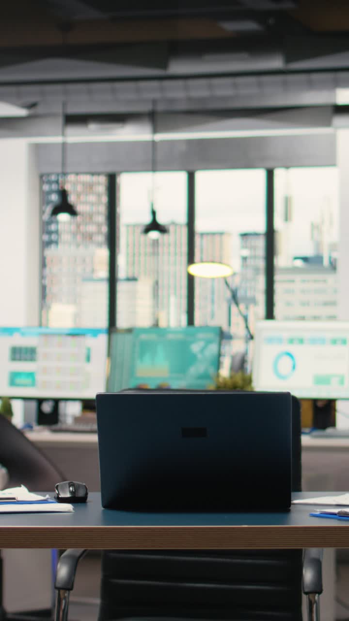 Vertical Video Quiet corporate space equipped with a laptop and performance reports