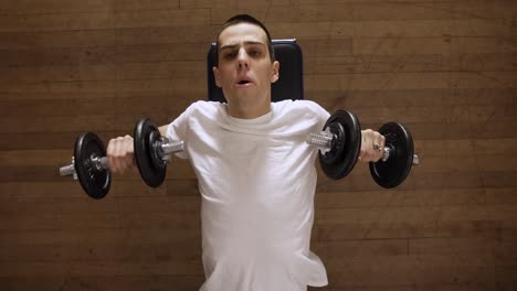 laying dumbbell bench press in an indoor gym - top view