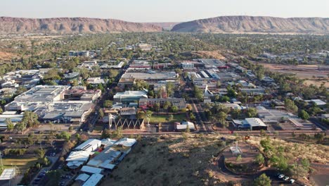 aerial footage moving sideways of anzac hill and the town of alice springs, mparntwe, with macdonnell ranges in the distance. northern territory, australia. august 2022.