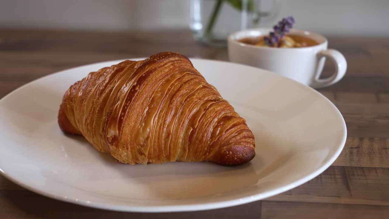 Perfectly flaky butter croissant paired with a lavendar latte, slider 4K