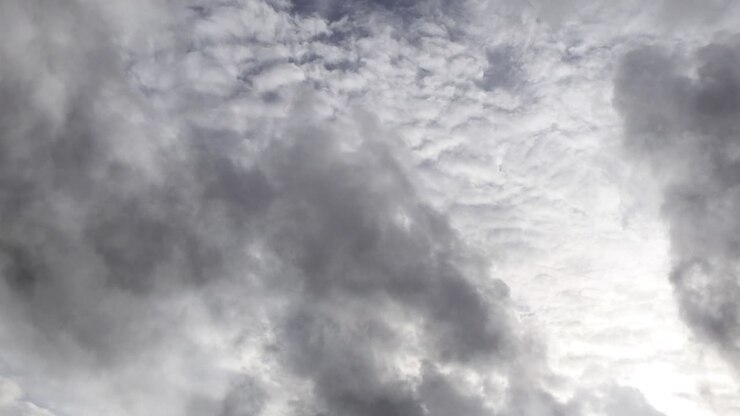 thick white clouds moving in the clear blue sky