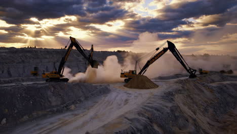 large excavators working in an open-pit mine at sunset, kicking up dust