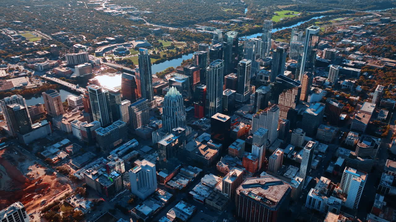 Austin, USA, 21 November 2025: Rising over modern high-rise vibrant downtown of Austin, Texas, USA. Sun reflects in the surface of the Colorado River