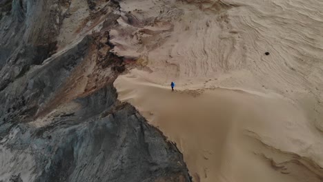 man standing on dune cliff in northern denmark