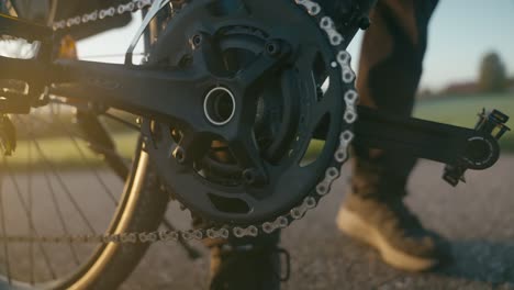 close-up of a cyclist's foot pedaling a bike at sunset, capturing motion and energy