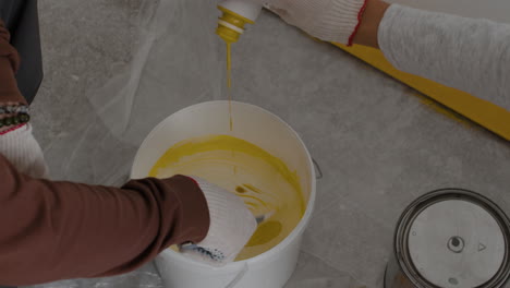mixing yellow paint: a diy home improvement project
