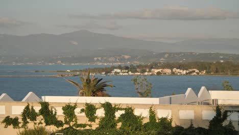 Panning-shot-of-urban-Greek-cities-in-the-background-and-some-beautiful-mountain-view-with-some-sea