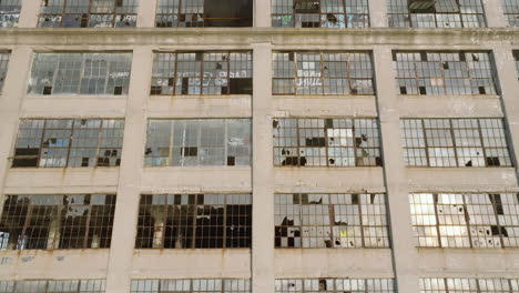 aerial view of the exterior of an abandoned warehouse at sunset.