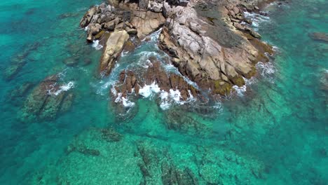 Bird-eye-drone-video-of-huge-granite-stones-near-the-Indian-ocean,-turquoise-transparent-water-and-crushing-waves,-Mahe,-Seychelles-30fps-1
