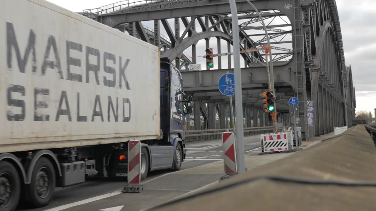 big truck driving over industrial bridge