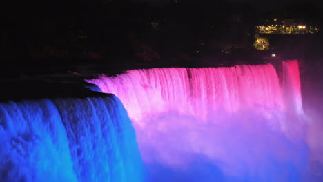 the american side of niagara falls brightly lit by multi-colored spotlights 4k video