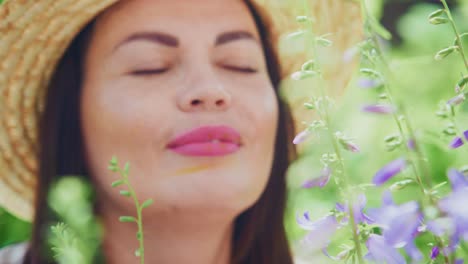 woman enjoying the beauty of flowers in a garden