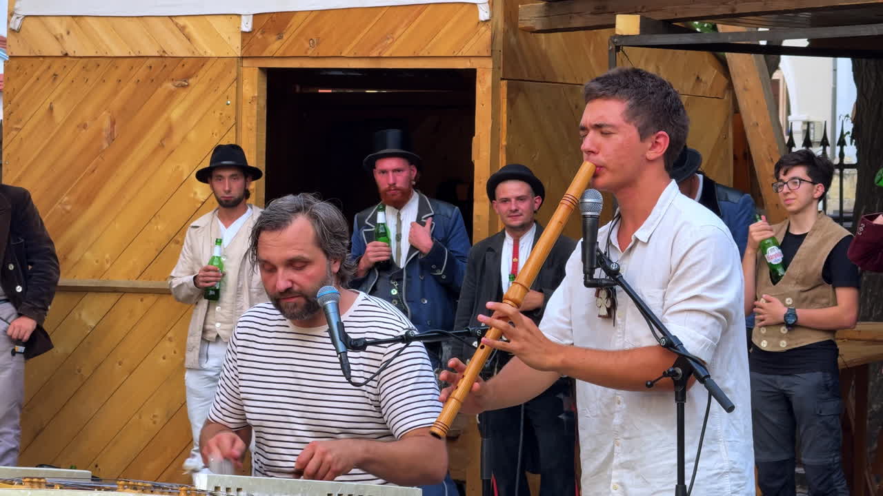 Sibiu, Romania, 1 July 2025: Traditional Musicians Performing in Sibiu. Local musicians in traditional attire performing in Sibiu, Romania, during a cultural event with instruments and folklore