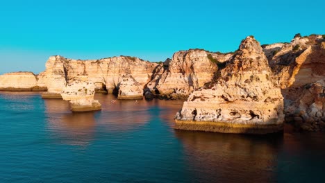 spectacular coastal cliffs at sunset in algarve, portugal