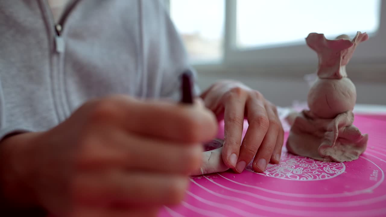 Child's Hands Molding Clay into Artistic Shapes