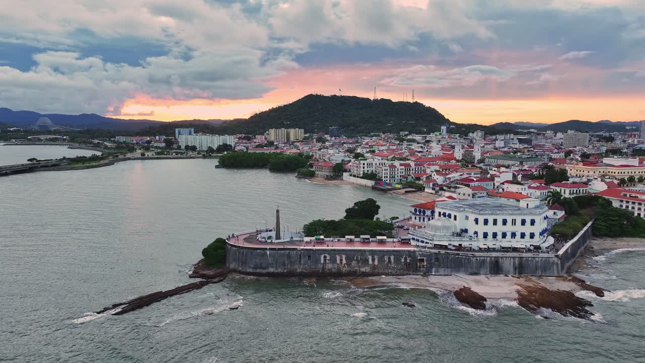 Drone shot of Las Bobedas in Casco Antiguo, Panama as it zooms out to reveal Ancon Hill during sunset