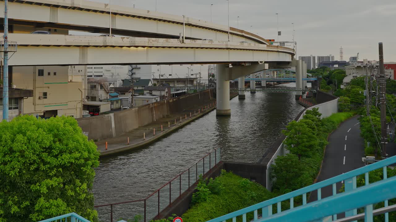 A view of the Ōyokogawa River flowing under a complex, multi-level elevated highway structure