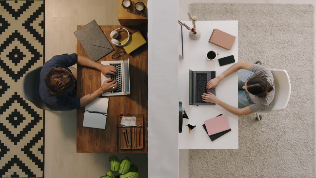 Top View of People Working on Laptops in Different Rooms