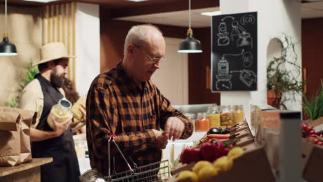 senior client buys food in reusable jars