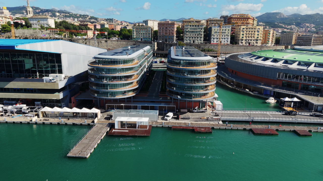 Aerial top view of modern waterfront buildings with harbor and city