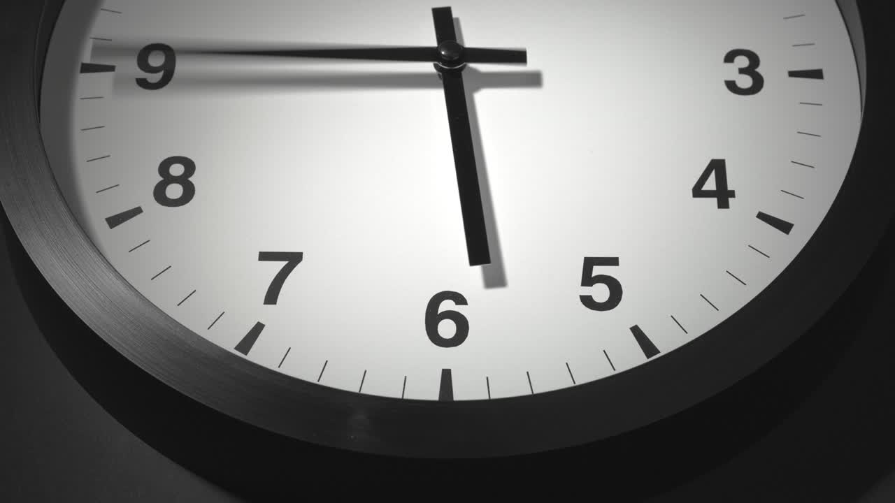 Clock Face in Time Lapse on Dark Grey Wall