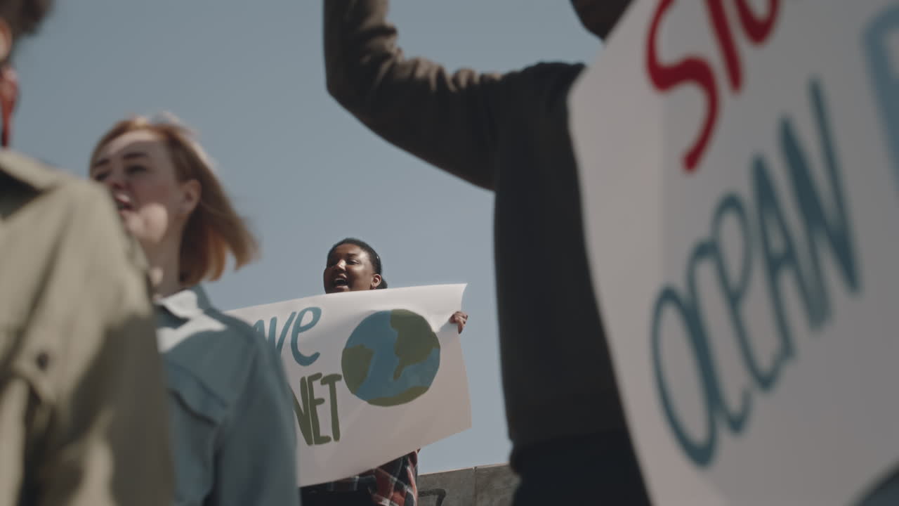 Environmental Activists with Posters on Protest against Pollution