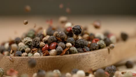 mixed peppercorns in a super slow motion. dry mix peppercorns close up.