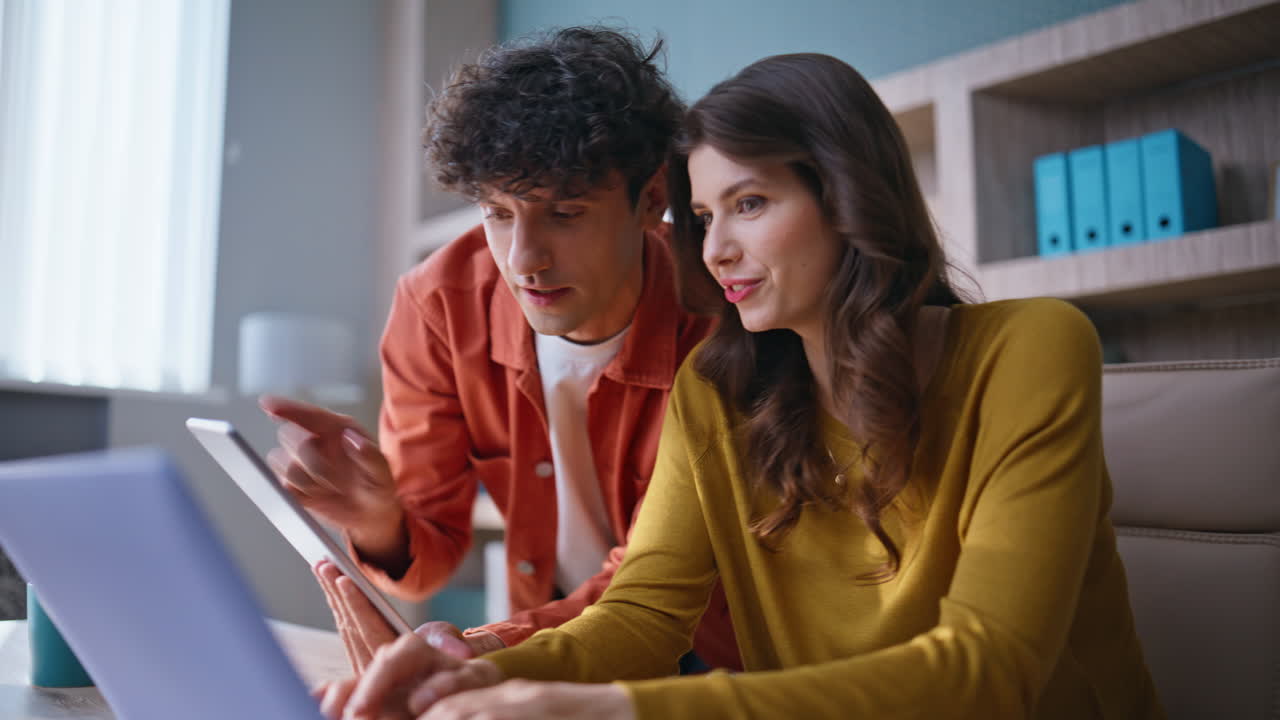Two entrepreneurs planning strategy of business startup looking laptop closeup