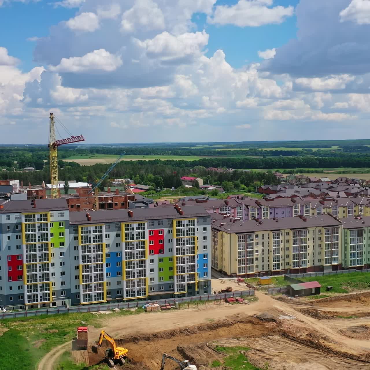 Modern district on the outskirts of a city. New multi storey buildings on the construction site. Building new residential complex. View from the air