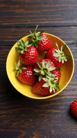 fresh strawberries in a yellow bowl
