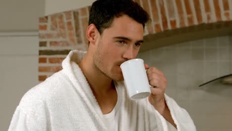 handsome man drinking a cup of coffee