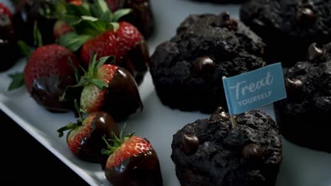 Rotating-shot-of-chocolate-beets-muffins-and-chocolate-covered-strawberries-for-valentines-day-candy-heart-love